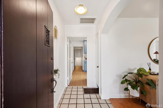 67 Rome St, San Francisco, CA 94112 - hallway with arched walkways and light wood-type flooring