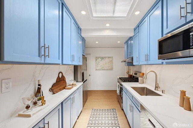 67 Rome St, San Francisco, CA 94112 - kitchen with stainless steel appliances, blue cabinetry, light wood finished floors, tasteful backsplash, and recessed lighting