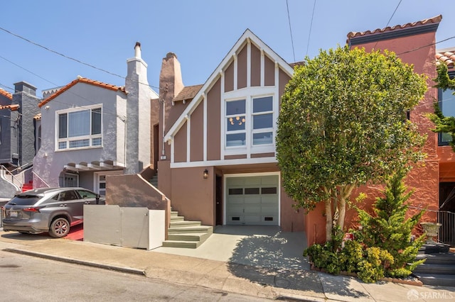 67 Rome St, San Francisco, CA 94112 - view of front of property with stucco siding, an attached garage, a chimney, and driveway