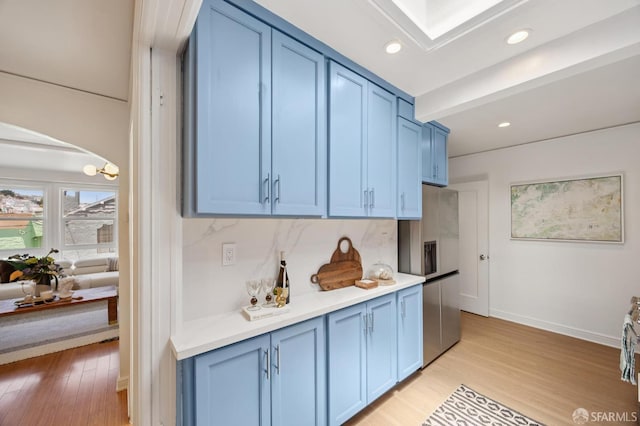 67 Rome St, San Francisco, CA 94112 - kitchen featuring blue cabinets, light countertops, light wood-style flooring, stainless steel refrigerator with ice dispenser, and recessed lighting