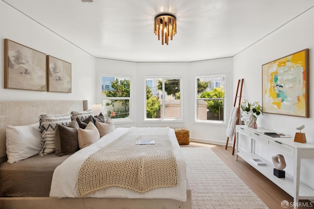 67 Rome St, San Francisco, CA 94112 - bedroom featuring multiple windows and wood finished floors