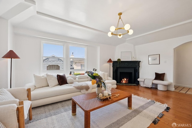 67 Rome St, San Francisco, CA 94112 - living area with arched walkways, wood finished floors, a warm lit fireplace, and a chandelier