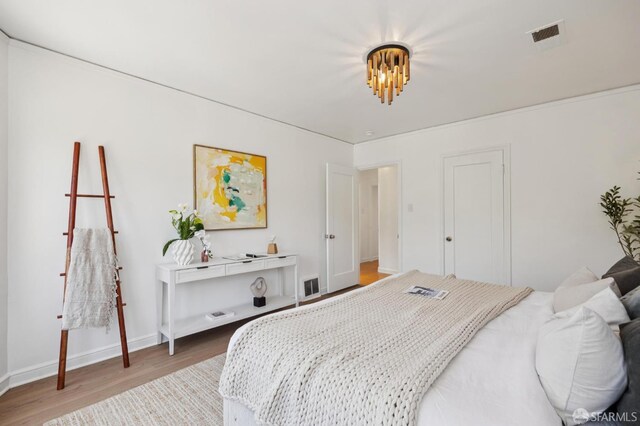 67 Rome St, San Francisco, CA 94112 - bedroom featuring wood finished floors and a chandelier