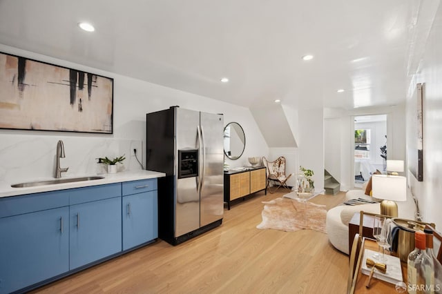 67 Rome St, San Francisco, CA 94112 - kitchen with stainless steel refrigerator with ice dispenser, light wood-style floors, blue cabinetry, light countertops, and recessed lighting