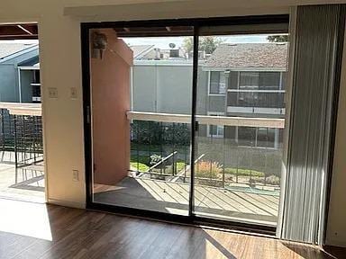 doorway to outside with a wealth of natural light and wood finished floors