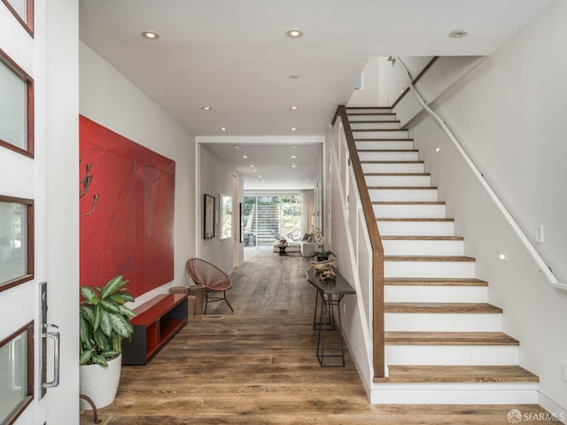 foyer with stairs, recessed lighting, and wood finished floors