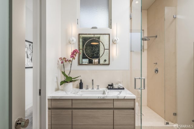 bathroom featuring a shower stall and vanity