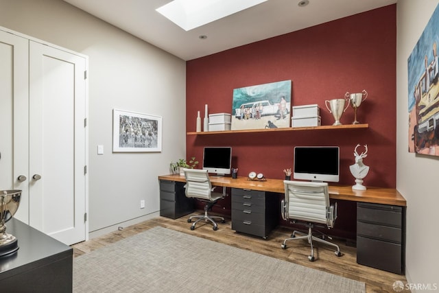 office featuring a skylight and wood finished floors