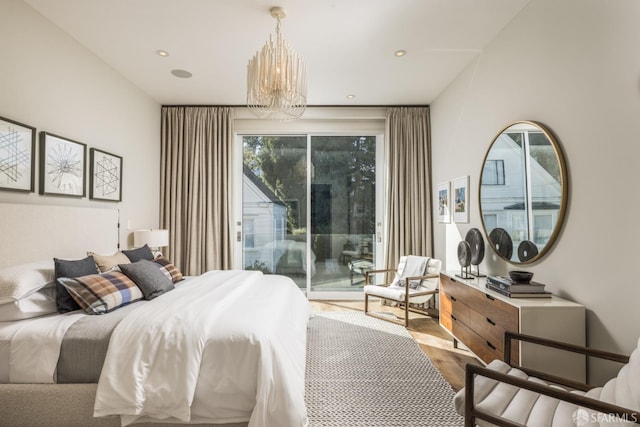 bedroom featuring access to exterior, recessed lighting, wood finished floors, and an inviting chandelier