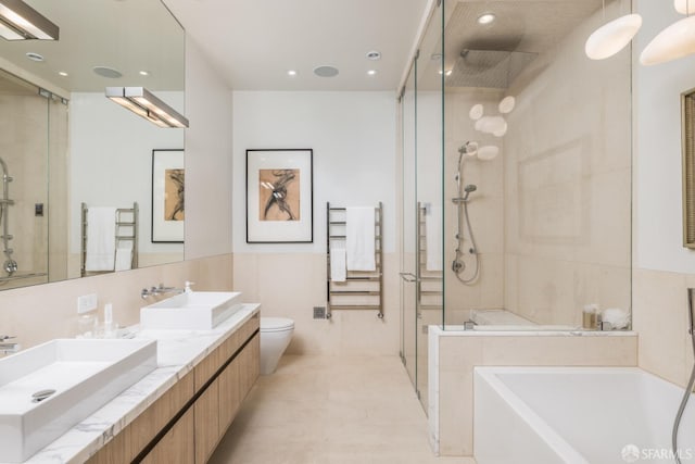 bathroom featuring a stall shower, tile walls, radiator heating unit, a sink, and a bath