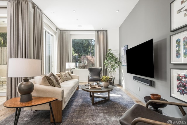 living area with wood finished floors and baseboards