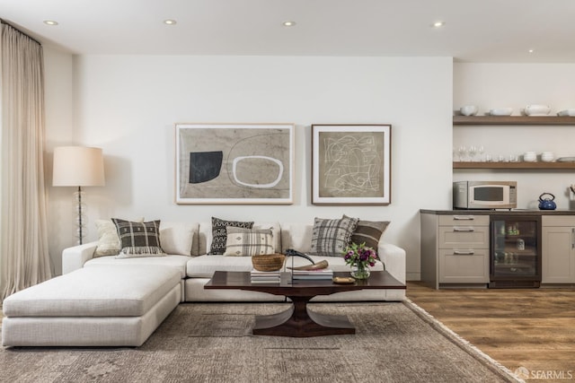 living area featuring beverage cooler, wood finished floors, and recessed lighting