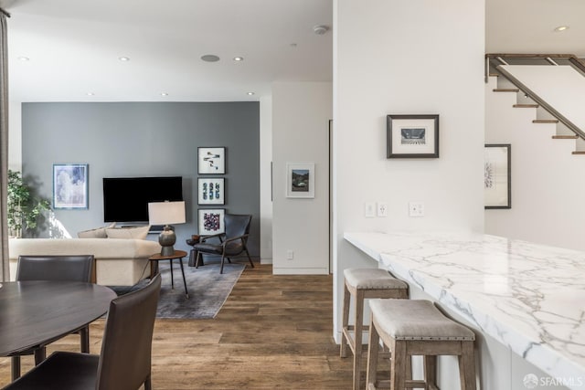 dining room featuring stairs, recessed lighting, and wood finished floors