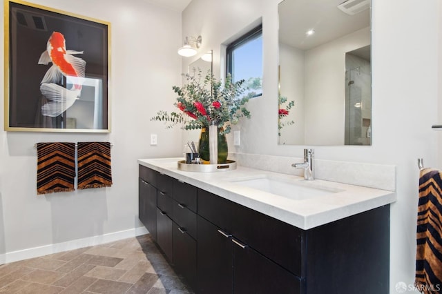 bathroom with double vanity, visible vents, baseboards, a sink, and recessed lighting