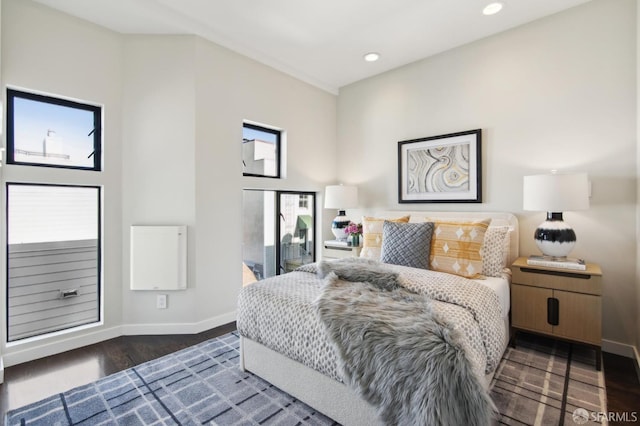 bedroom with recessed lighting, multiple windows, dark wood finished floors, and baseboards