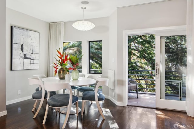 dining area featuring baseboards, dark wood-type flooring, and a healthy amount of sunlight