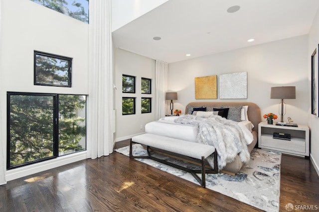 bedroom featuring dark wood-style floors, baseboards, and recessed lighting