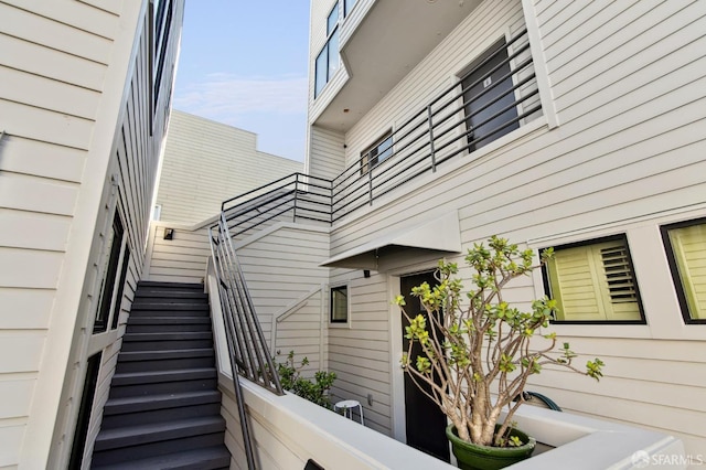 view of side of property featuring stairs