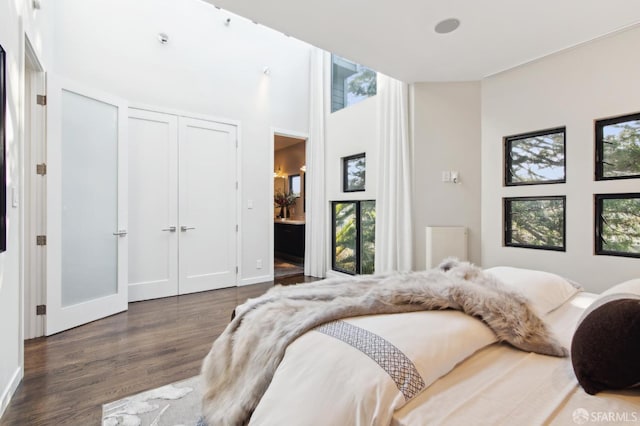 bedroom with dark wood-style floors