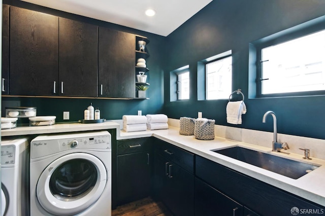 laundry area with washer and dryer, cabinet space, a sink, and recessed lighting