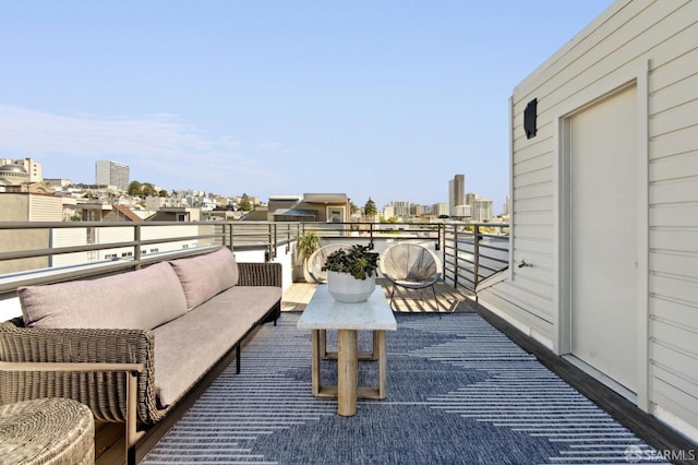 balcony featuring outdoor lounge area and a city view