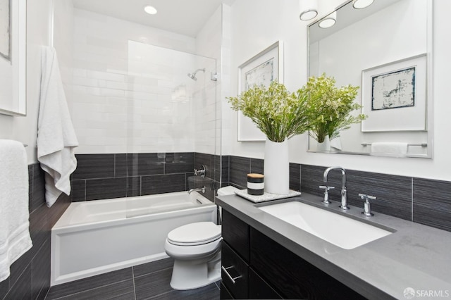 bathroom featuring toilet, bathtub / shower combination, and vanity