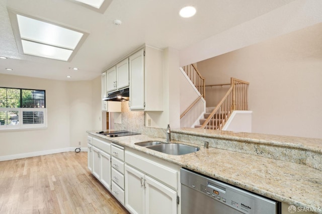 kitchen with sink, light wood-type flooring, dishwasher, decorative backsplash, and white cabinets