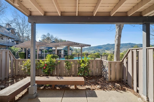 view of patio / terrace with a mountain view and a pergola