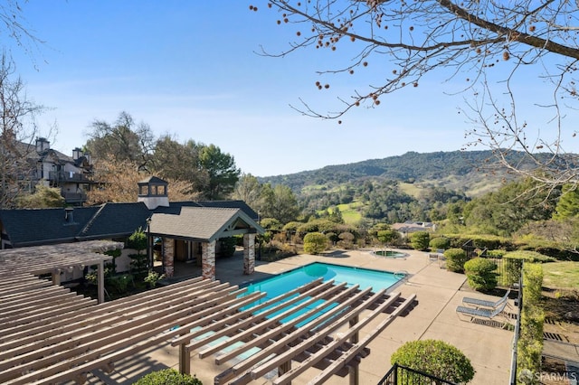 view of swimming pool featuring a pergola and a patio area