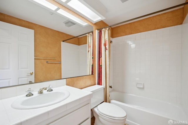 full bathroom with vanity, toilet, and shower / tub combo with curtain