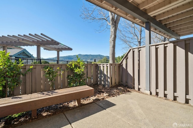 view of patio / terrace featuring a mountain view and a pergola