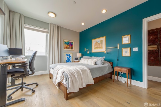 bedroom with recessed lighting, baseboards, and wood finished floors