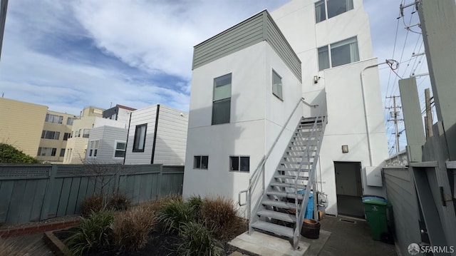 exterior space featuring stairs and fence