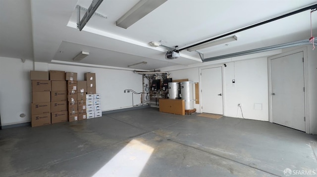 garage featuring water heater and a garage door opener