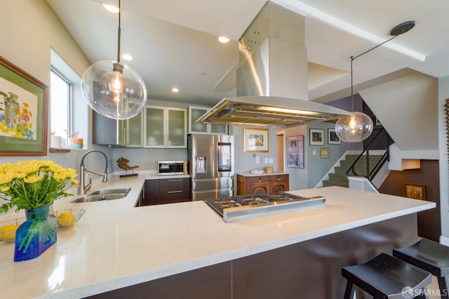 kitchen featuring stainless steel appliances, a peninsula, a sink, island exhaust hood, and glass insert cabinets