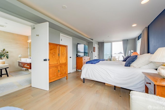 bedroom featuring light wood-type flooring and visible vents