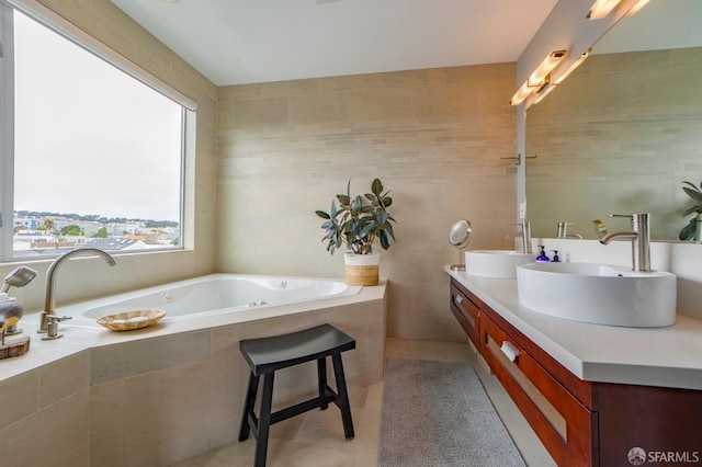 full bathroom featuring double vanity, tile patterned flooring, a sink, and tile walls