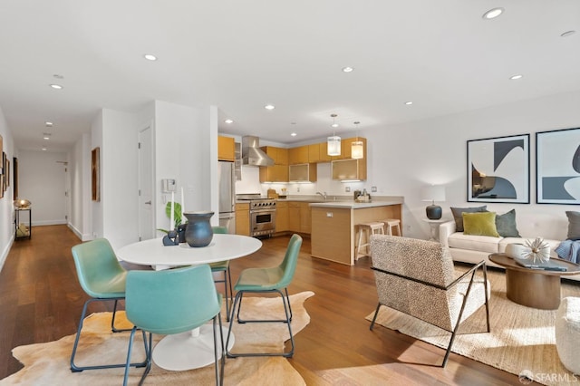 dining area featuring sink and light hardwood / wood-style flooring