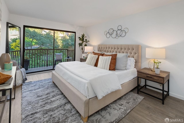 bedroom with hardwood / wood-style floors and access to exterior