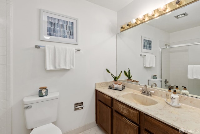 bathroom featuring vanity, an enclosed shower, and toilet