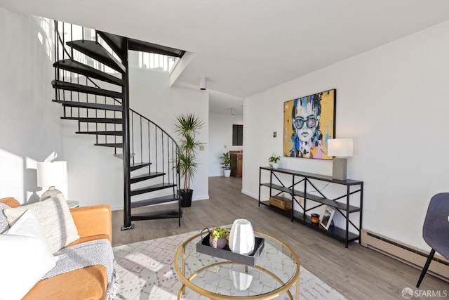 living room featuring hardwood / wood-style flooring and a baseboard heating unit