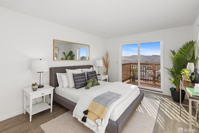 bedroom featuring dark hardwood / wood-style floors and access to exterior