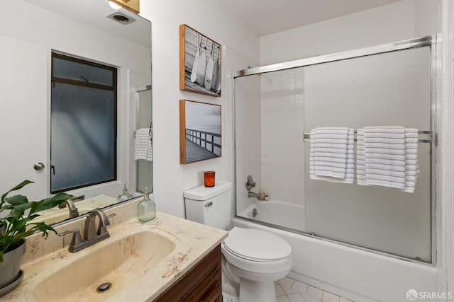 full bathroom with vanity, bath / shower combo with glass door, and toilet