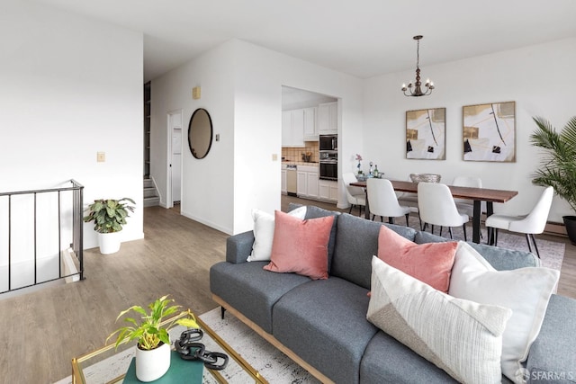 living room with wood-type flooring and a chandelier