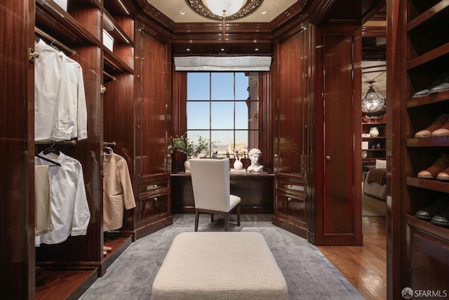 interior space featuring wood walls, light hardwood / wood-style floors, and crown molding