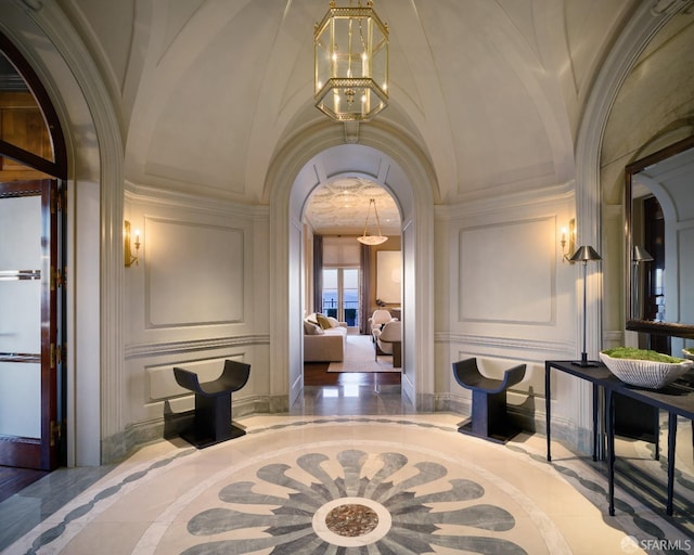 interior space featuring crown molding and a chandelier