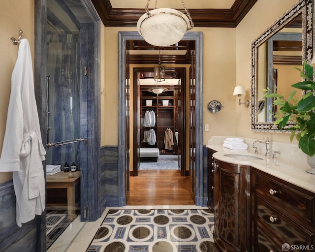 bathroom with hardwood / wood-style floors, vanity, and crown molding