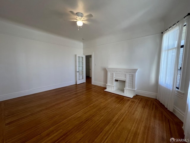 unfurnished living room featuring ceiling fan and hardwood / wood-style flooring