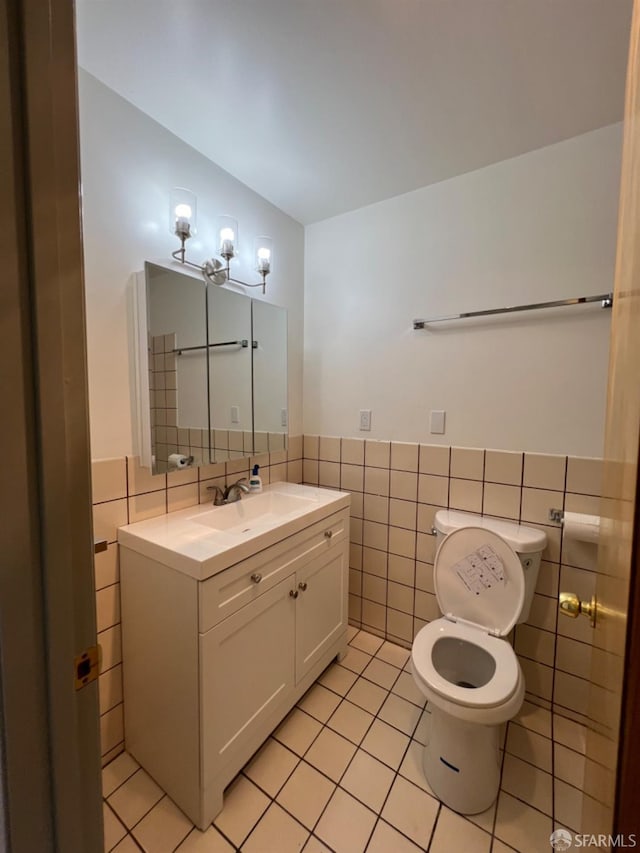 bathroom featuring vanity, tile walls, tile patterned flooring, and toilet