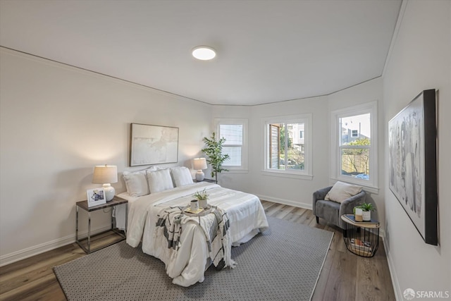 bedroom featuring dark hardwood / wood-style floors and crown molding